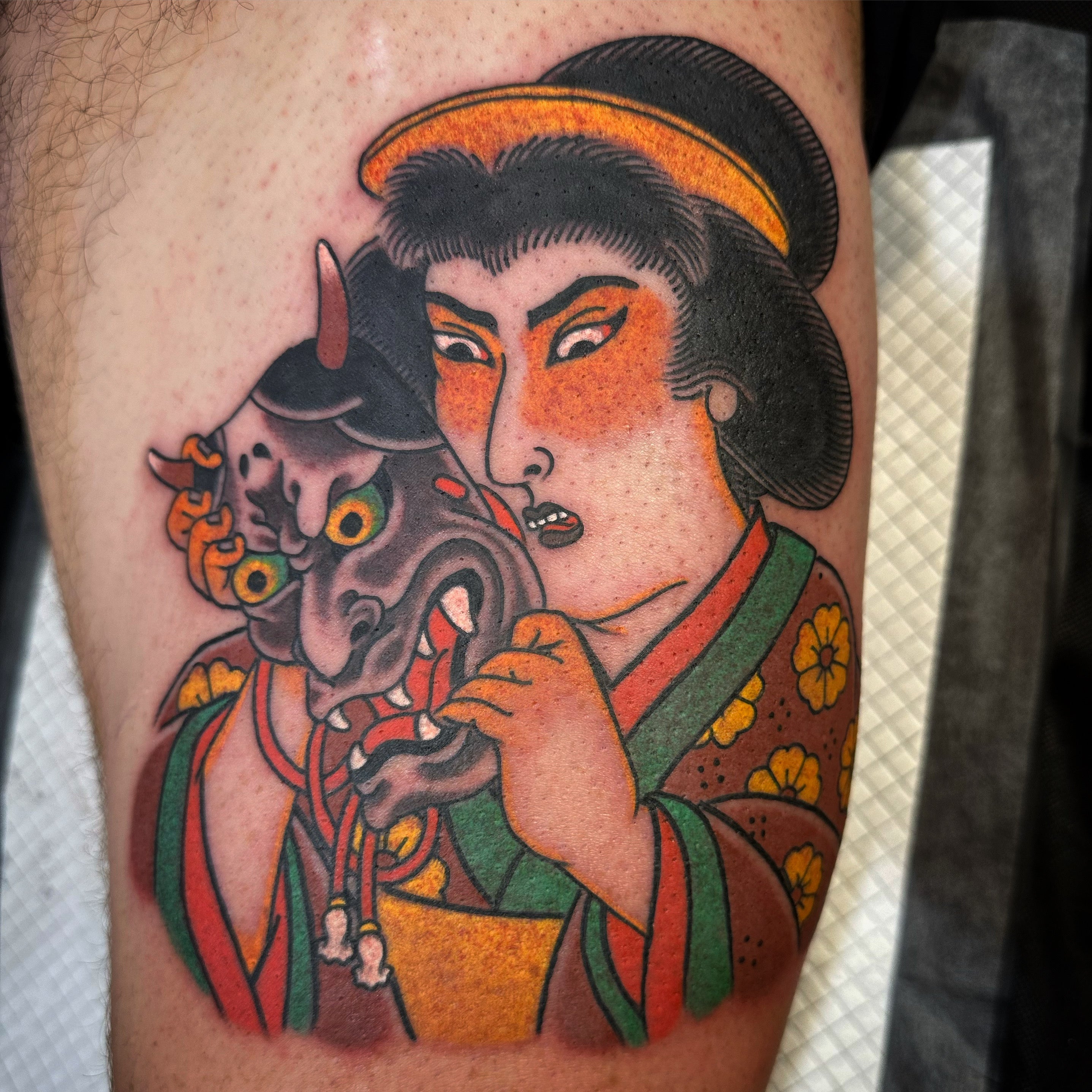 Geisha holding Hannya mask tattoo