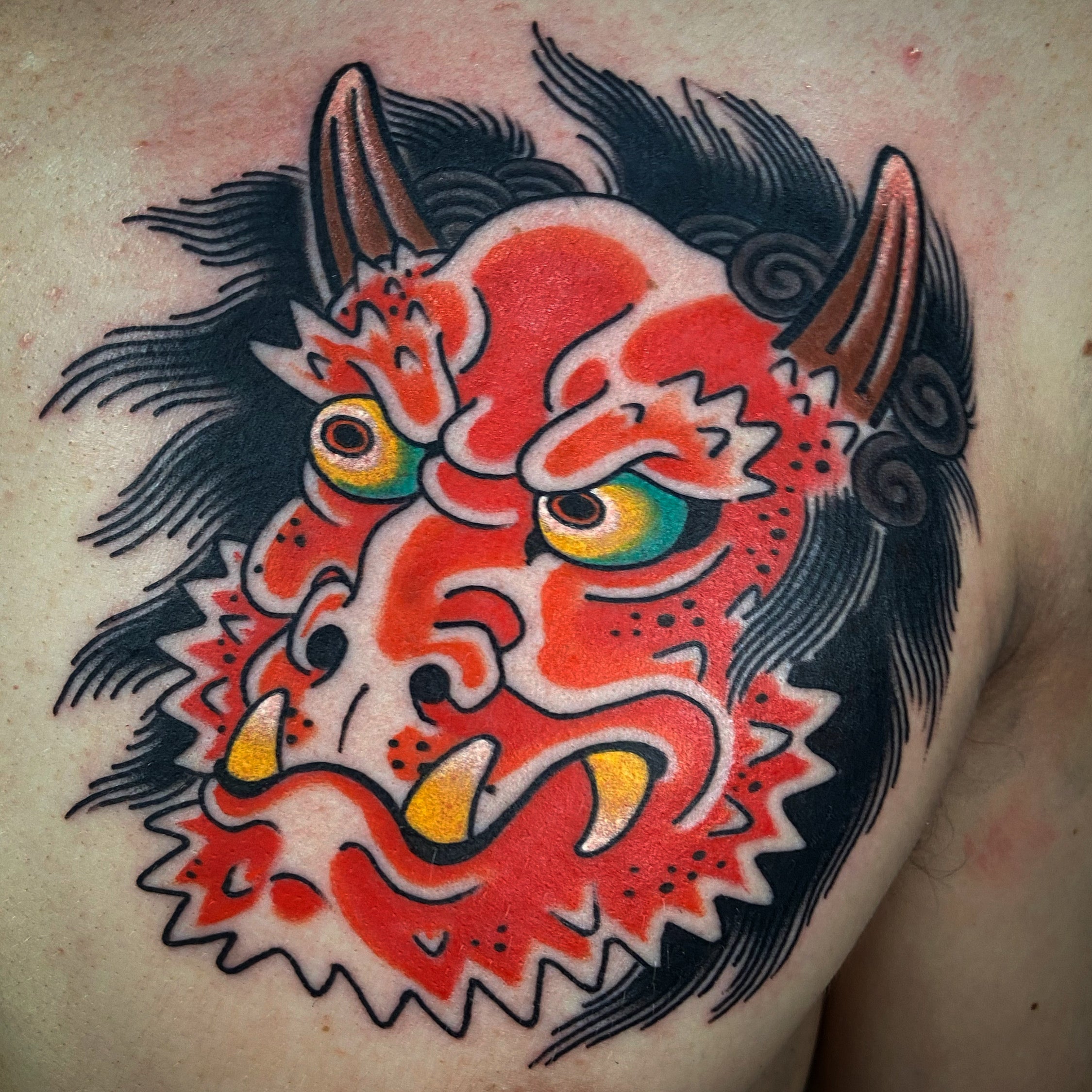 Red Japanese oni chest tattoo