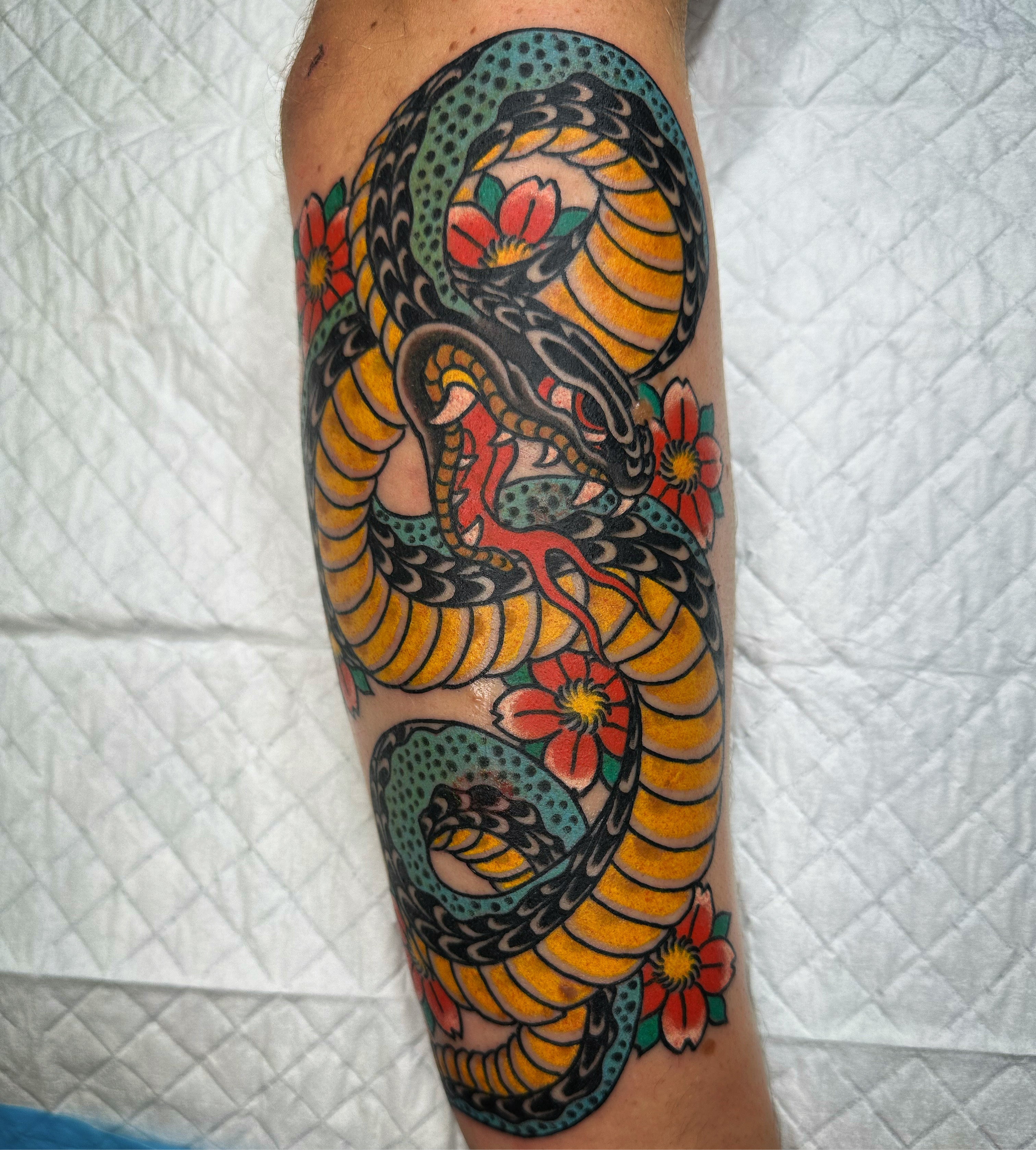 Japanese snake with cherry blossoms tattoo